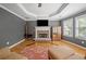 Living room offers a stone fireplace, hardwood floors, large windows, and a tray ceiling at 3438 Winborn Walk Northwest Nw, Kennesaw, GA 30152