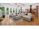 Open-concept living room with hardwood floors, large windows, and seamless flow to the kitchen and dining area at 3438 Winborn Walk Northwest Nw, Kennesaw, GA 30152