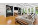 Cozy living room with hardwood floors, custom built-ins, a fireplace, and comfortable seating for relaxation at 3438 Winborn Walk Northwest Nw, Kennesaw, GA 30152