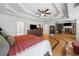 Spacious main bedroom featuring a large bed, coffered ceiling, and hardwood floors at 3438 Winborn Walk Northwest Nw, Kennesaw, GA 30152