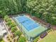Aerial view of a blue and green tennis court surrounded by trees at 3438 Winborn Walk Northwest Nw, Kennesaw, GA 30152