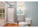 A bathroom with a framed mirror, shower, modern toilet, and sink with vanity at 1488 White Columns Blvd, Canton, GA 30115