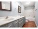 Bathroom featuring a double vanity and a shower-tub combo at 1488 White Columns Blvd, Canton, GA 30115