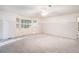Large bedroom offers natural light with built-in storage below the bay windows and neutral carpet at 1488 White Columns Blvd, Canton, GA 30115