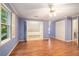 Bright bedroom offers hardwood floors, a ceiling fan, a window with shutters, and closet space at 1488 White Columns Blvd, Canton, GA 30115