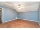 Spacious bedroom with hardwood floors, a modern ceiling fan, and natural light, providing a comfortable atmosphere at 1488 White Columns Blvd, Canton, GA 30115