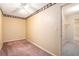 This bedroom features neutral carpeting, a ceiling fan, a walk-in closet, and neutral paint at 1488 White Columns Blvd, Canton, GA 30115