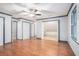 A spacious bedroom showcases hardwood floors, a ceiling fan, three closets and a window for natural light at 1488 White Columns Blvd, Canton, GA 30115