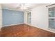 A bright bedroom features hardwood floors, a ceiling fan, and natural light from windows with wooden shutters at 1488 White Columns Blvd, Canton, GA 30115