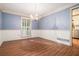 Inviting dining room with a charming chandelier, hardwood floors, and a view into the kitchen at 1488 White Columns Blvd, Canton, GA 30115