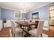 Inviting dining room with blue wallpaper, chandelier lighting, and a formal table setting at 1488 White Columns Blvd, Canton, GA 30115