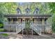 Charming home with a large front porch, detailed railings and three dormer windows above at 1488 White Columns Blvd, Canton, GA 30115
