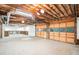 A large garage with a rolling door, high ceiling, and storage shelves offers ample parking and storage space at 1488 White Columns Blvd, Canton, GA 30115