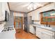 Bright kitchen showcasing gas range, refrigerator, and a large window at 1488 White Columns Blvd, Canton, GA 30115
