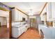 Traditional kitchen featuring white cabinets, stainless steel appliances, and wood flooring at 1488 White Columns Blvd, Canton, GA 30115