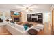 Bright living room featuring a stone fireplace, built-in shelves, and neutral furniture at 1488 White Columns Blvd, Canton, GA 30115