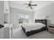 Bedroom with large window, ceiling fan, and dedicated vanity provides a comfortable retreat at 1754 Water Springs Way, Dacula, GA 30019