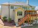 The house features an outdoor living area with a wooden deck and steps leading to the spacious backyard at 1754 Water Springs Way, Dacula, GA 30019