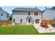 Backyard features a green lawn, fence, patio, and manicured landscaping at 181 Weatherstone Dr, Woodstock, GA 30188