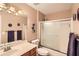 Clean bathroom with neutral walls, single sink vanity, toilet, and glass enclosed tub and shower at 181 Weatherstone Dr, Woodstock, GA 30188