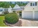 Close up of a charming home showcasing verdant landscaping and a convenient two-car garage at 181 Weatherstone Dr, Woodstock, GA 30188