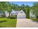 Charming traditional home featuring a well-manicured lawn and a two-car garage at 181 Weatherstone Dr, Woodstock, GA 30188