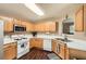 Bright kitchen features wood cabinets, white countertops, and stainless steel appliances at 181 Weatherstone Dr, Woodstock, GA 30188