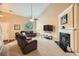 Spacious living room features a cozy fireplace, plush carpeting, and plenty of natural light at 181 Weatherstone Dr, Woodstock, GA 30188