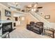 Open living room features a grand staircase, fireplace, and neutral carpeting at 181 Weatherstone Dr, Woodstock, GA 30188