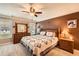 Cozy main bedroom with carpeted floors, neutral colored walls, ceiling fan and an ensuite bathroom at 181 Weatherstone Dr, Woodstock, GA 30188