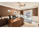 Well-lit home office featuring a wooden desk, neutral carpet, and sliding glass door leading to outdoor patio at 181 Weatherstone Dr, Woodstock, GA 30188