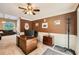 Well-lit home office featuring a wooden desk, neutral carpet, and views into the living area at 181 Weatherstone Dr, Woodstock, GA 30188