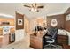 Well-lit home office featuring a wooden desk, neutral carpet, and views into the kitchen and living areas at 181 Weatherstone Dr, Woodstock, GA 30188
