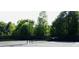 Community tennis courts are surrounded by mature trees at 181 Weatherstone Dr, Woodstock, GA 30188