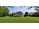Beautiful home exterior with a lush green lawn and charming, elevated, screened-in back porch at 5690 Rutland Trce, Lithonia, GA 30058