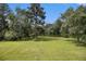 Large backyard featuring mature trees and view of the lake at 5690 Rutland Trce, Lithonia, GA 30058