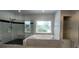 Bathroom with glass shower, soaking tub, linen closet, and a large window at 5690 Rutland Trce, Lithonia, GA 30058