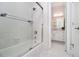 Bathroom features a shower with a glass door and a view to the sink and white vanity area and tile floors at 5690 Rutland Trce, Lithonia, GA 30058