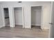 Bedroom with closet and bath access, neutral walls, and light, wood-look flooring at 5690 Rutland Trce, Lithonia, GA 30058