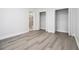 Bedroom with grey wood flooring and a view of the bathroom and closets at 5690 Rutland Trce, Lithonia, GA 30058