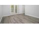 Bedroom with grey wood flooring and patio doors at 5690 Rutland Trce, Lithonia, GA 30058