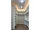 Spacious walk-in closet with custom shelving and ample storage space at 5690 Rutland Trce, Lithonia, GA 30058