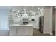 Modern kitchen with white cabinets, a kitchen island with stainless steel appliances, and stylish backsplash at 5690 Rutland Trce, Lithonia, GA 30058