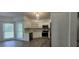 Bright eat-in kitchen featuring stainless steel appliances, updated cabinets, a mosaic backsplash, and wood-look floors at 5690 Rutland Trce, Lithonia, GA 30058