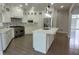 Contemporary kitchen showcasing white cabinetry, a large island, stainless steel appliances, and modern finishes at 5690 Rutland Trce, Lithonia, GA 30058