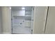 Well-lit laundry room with tiled floor, overhead cabinets, a sink and counter space, and washer/dryer hookups at 5690 Rutland Trce, Lithonia, GA 30058