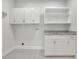 Bright laundry room features built-in cabinets, sink and plenty of storage at 5690 Rutland Trce, Lithonia, GA 30058