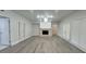 Spacious living room with stone fireplace, ceiling fan, and plenty of natural light from large windows at 5690 Rutland Trce, Lithonia, GA 30058