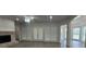 Living room with fireplace, ceiling fan, and natural light streaming through French doors and bay windows at 5690 Rutland Trce, Lithonia, GA 30058