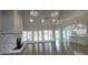 Open-concept living room boasts a fireplace, vaulted ceilings, modern lights, and a seamless flow to the kitchen at 5690 Rutland Trce, Lithonia, GA 30058